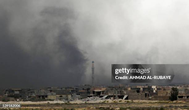 Smoke billows from Fallujah's southern Shuhada neighbourhood following shelling during an operation by Iraqi government forces, backed by air support...