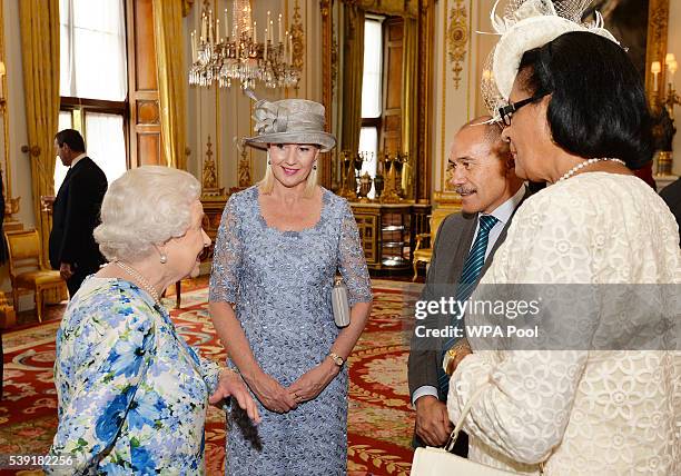 Queen Elizabeth II talks to Sir Jerry Mateparae of New Zealand and Dame Cecile La Grande of Grenada during a reception during a reception ahead of a...