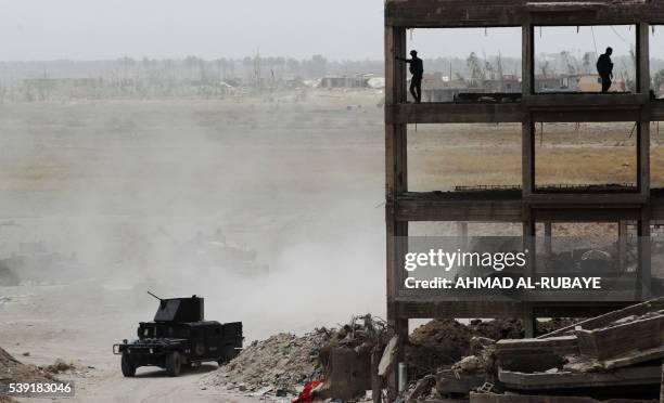 Iraqi government forces and elite counterterrorism service patrol from the edge of Shuhada neighbourhood, southern Fallujah, during an operation to...