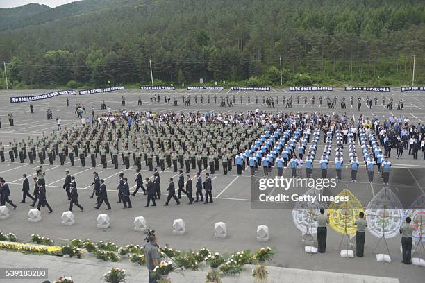 Representatives of armed police soldiers and students attend a memorial service held for Chinese UN peacekeeping soldier Shen Liangliang, who was...