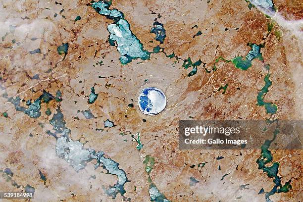 Satellite image of the Pingualuit asteroid impact crater in Quebec, Canada on July 19, 2015. Pingualuk Lake fills the centre of the crater and is...