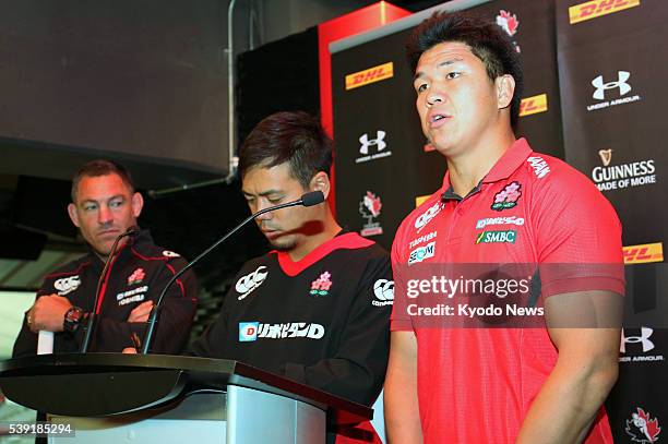 Japan interim coach Mark Hammett, interpreter Hidenori Sato and center Harumichi Tatekawa attend a press conference in Vancouver on June 9 as Hammett...