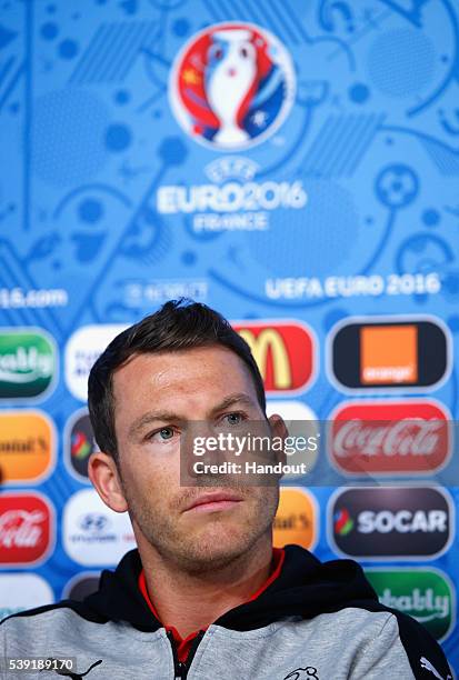 In this handout image provided by UEFA, Captain, Stephan Lichtsteiner of Switzerland talks to the media during the Switzerland Press Conference at...