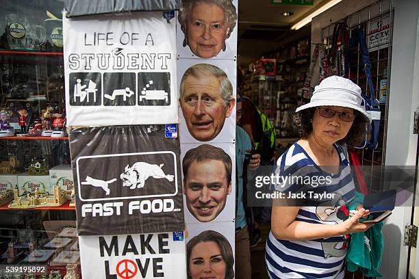 Woman walks out of a souvenir shop selling various Royal-themed gifts among it's other novelty items on June 10, 2016 in Windsor, England. Windsor,...