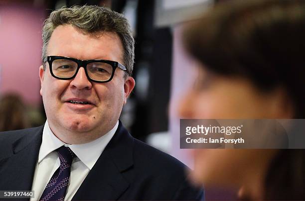 Deputy leader of the Labour Party Tom Watson listens as Labour's Shadow Cabinet Minister Gloria de Piero speaks with a group of women voters to talk...