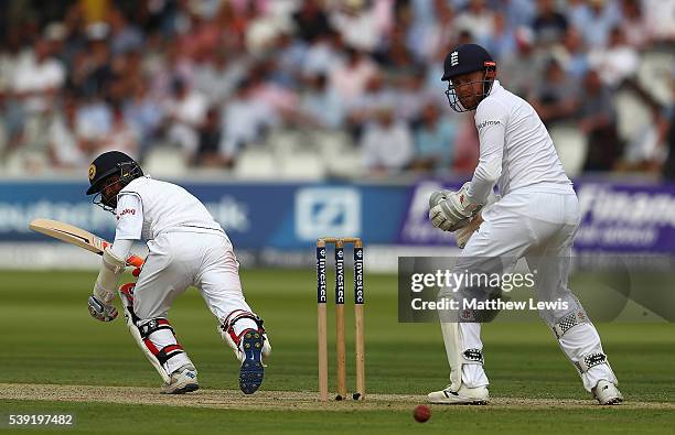 Kaushal Silva of Sri Lanka sweeps the ball towards the boundary, as Jonny Bairstow of England looks on during day two of the 3rd Investec Test match...