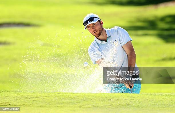 Russell Henley hits out of a bunker on the 16th hole during the second round of the FedEx St. Jude Classic at TPC Southwind on June 10, 2016 in...