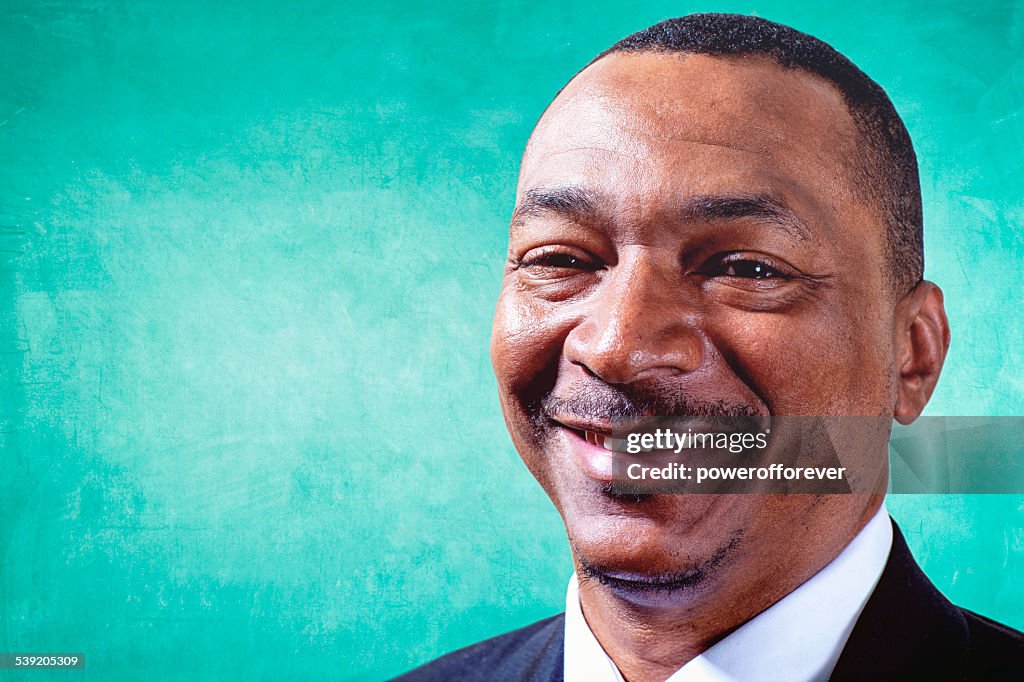 African American Teacher in Front of Blackboard