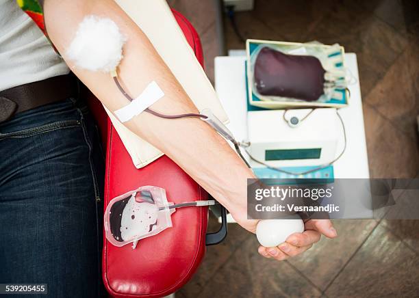 close up of man hand on blood donation - donation stock pictures, royalty-free photos & images