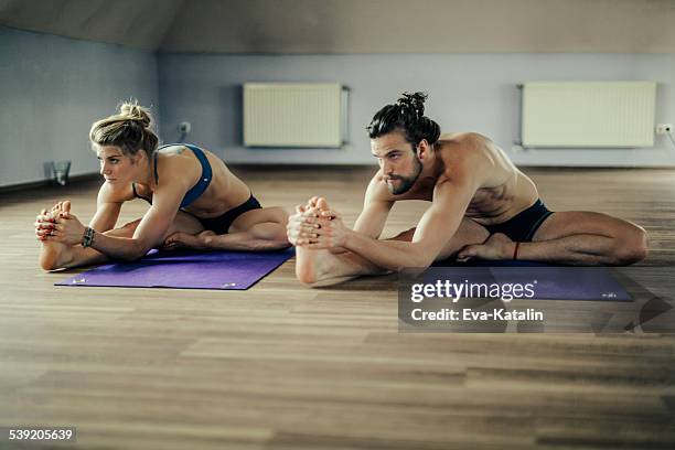 young people exercising yoga - hot yoga stock pictures, royalty-free photos & images