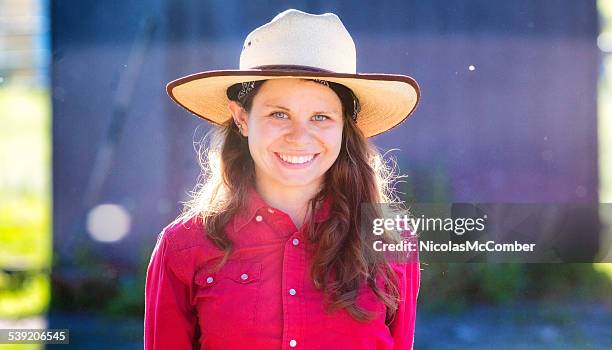 beautiful female ranch employee lit by sunset - parkwachter stockfoto's en -beelden