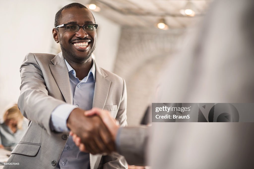 African American businessman shaking hands with his colleague.