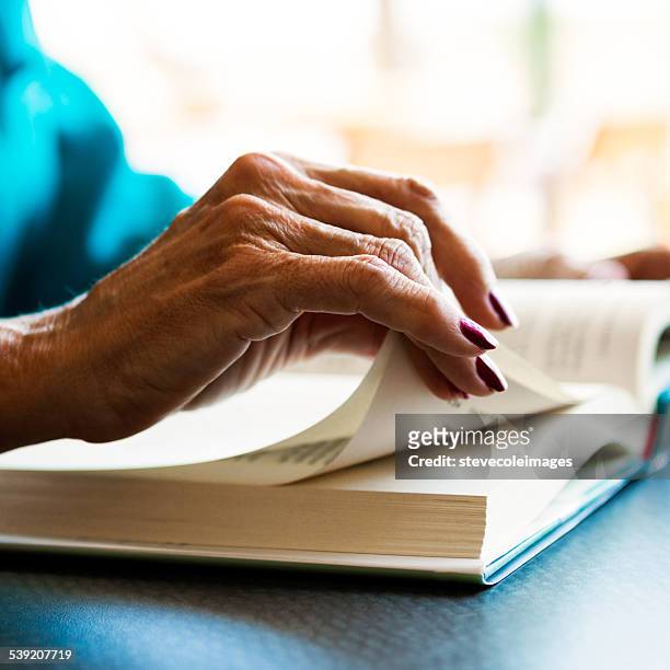 reading book - book hand stock pictures, royalty-free photos & images