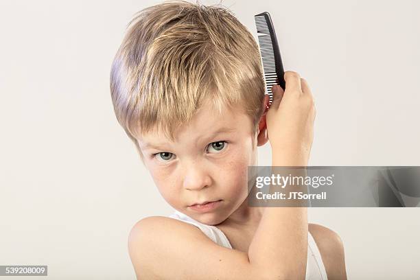 cute little boy combing his hair - hair comb stock pictures, royalty-free photos & images