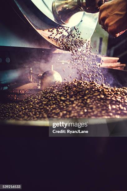 coffee roaster in action - coffee manufacturing stock pictures, royalty-free photos & images