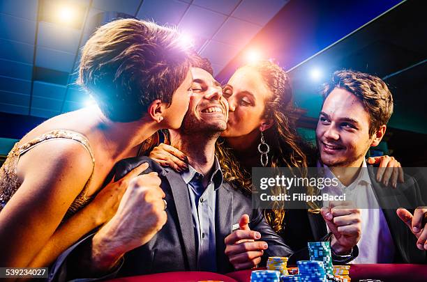 group of friends winning at casino - table fan stock pictures, royalty-free photos & images