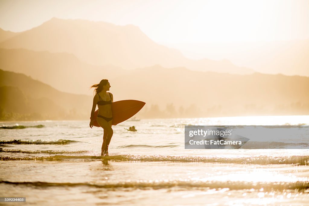 Attractive female surfer at the beach