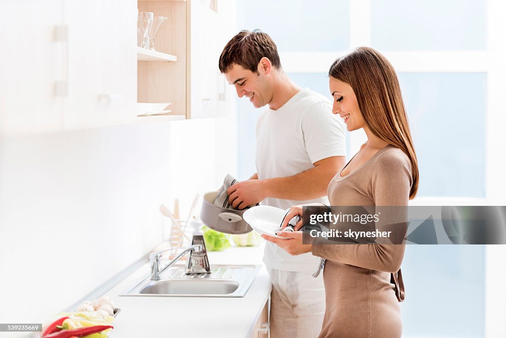 Couple washing dishes.
