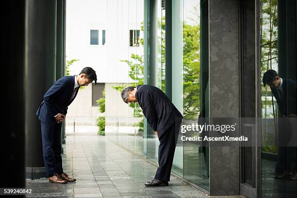 traditional japanese business greeting - bowing stock pictures, royalty-free photos & images