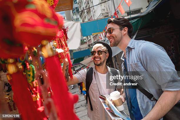 gay couple in a flee market in hong kong - china tourism stock pictures, royalty-free photos & images