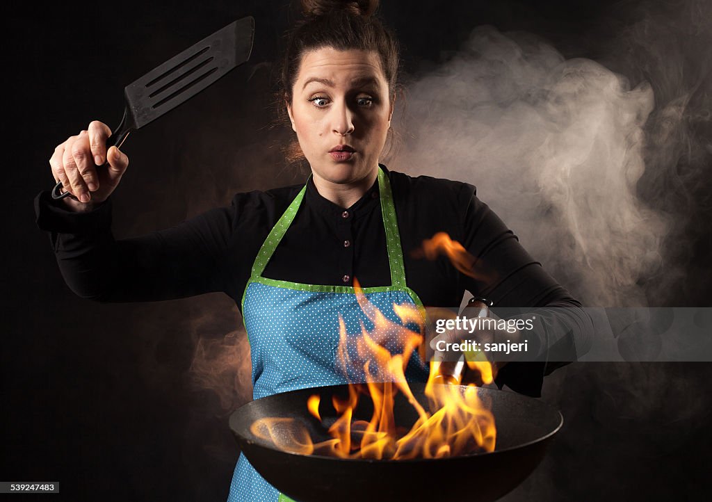 Fire cook woman - wok cooking