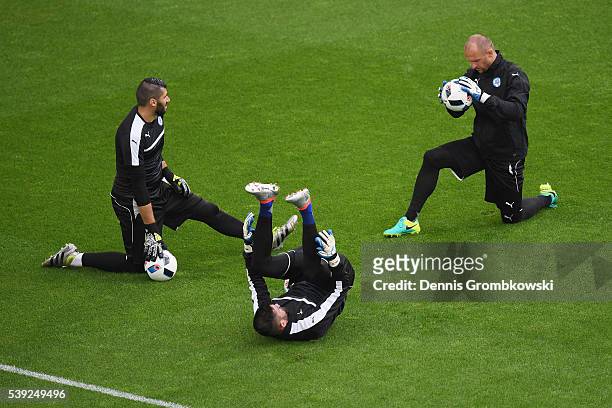 Goalkeepers Matus Kozacik, Jan Mucha and Jan Notova of Slovakia stretch during a training session ahead of their UEFA Euro 2016 Goup B match at...