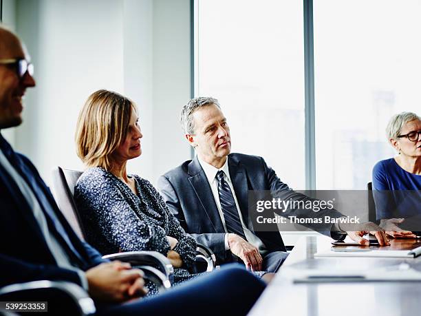 group of business executives in meeting in office - bussines group suit tie fotografías e imágenes de stock