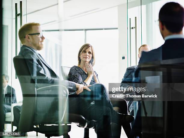 business executive listening to presentation - completo da uomo foto e immagini stock