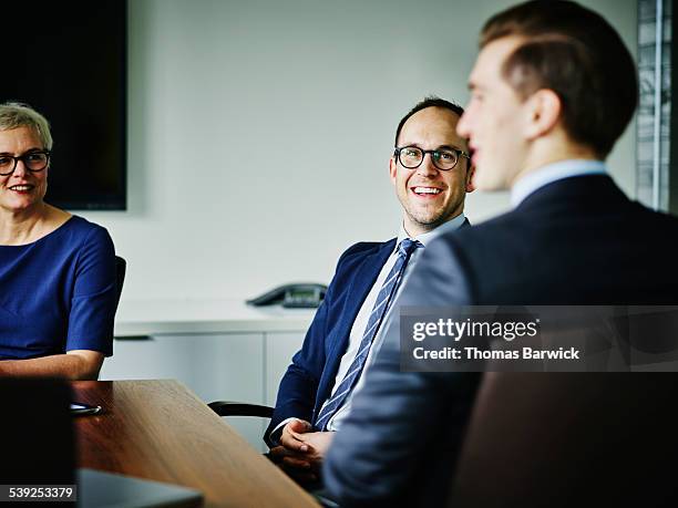 laughing businesspeople meeting in conference room - bussines group suit tie stock-fotos und bilder