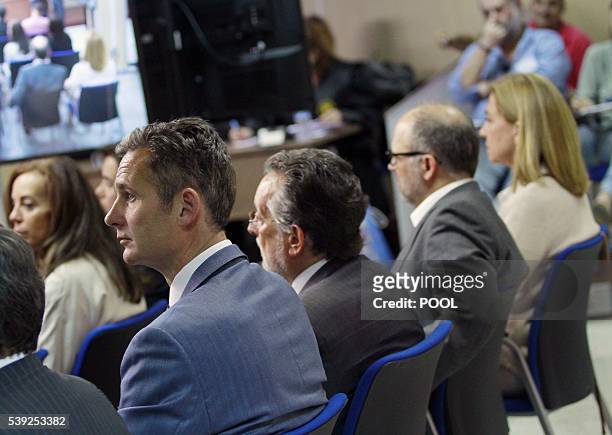 Former Olympic handball player Inaki Urdangarin and his wife Spain's Princess Cristina sit during a hearing held in the courtroom at the Balearic...