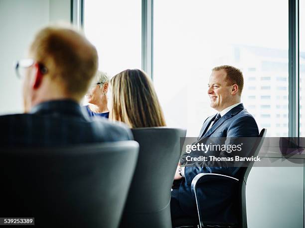 smiling business executive in meeting - bussines group suit tie stock pictures, royalty-free photos & images