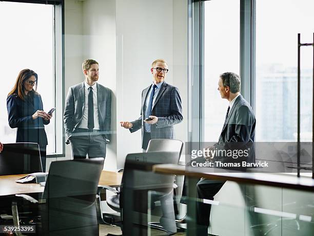 business executives in discussion after meeting - white business suit stock pictures, royalty-free photos & images