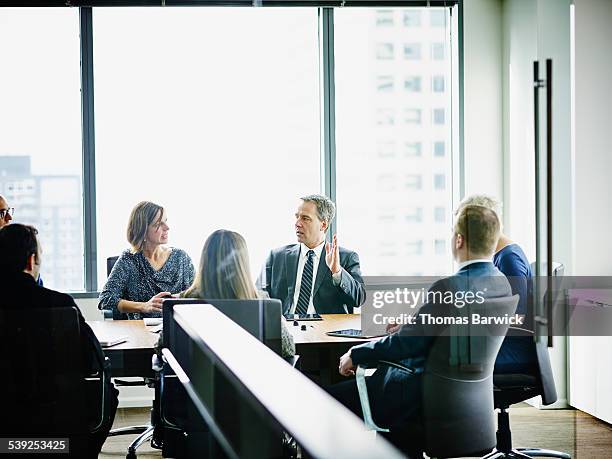 male business executive leading project discussion - taking control stock pictures, royalty-free photos & images