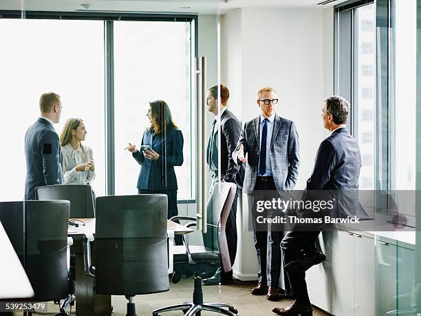 business executives in discussion after meeting - meeting candid office suit stockfoto's en -beelden