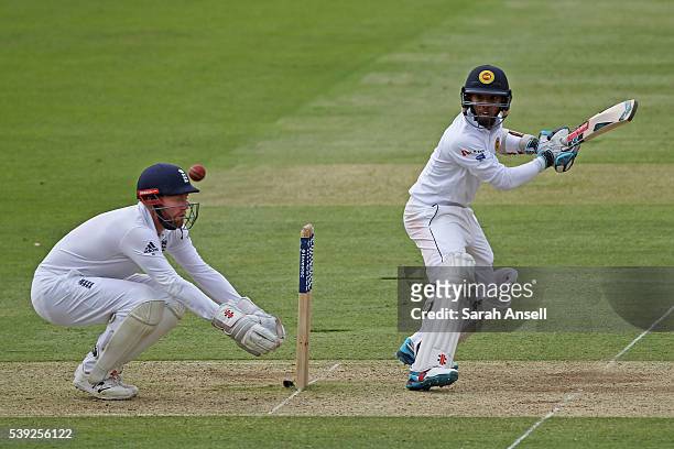 Kusal Mendis hits out as England wicket keeper Jonny Bairstow looks on during day two of the 3rd Investec Test match between England and Sri Lanka at...