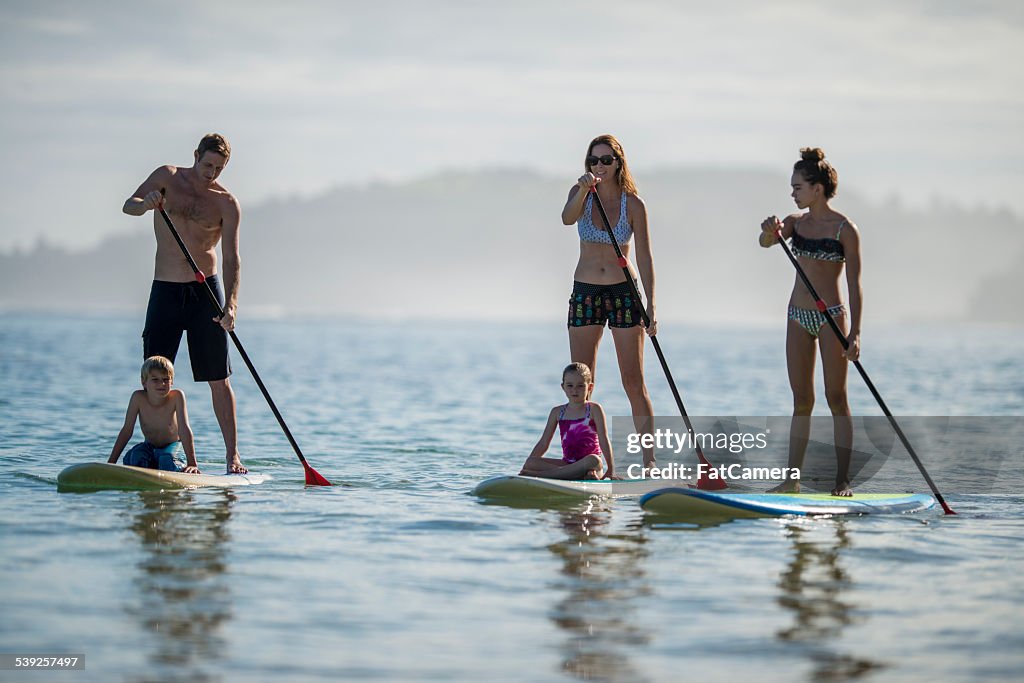 Family paddleboarding in Hawaii