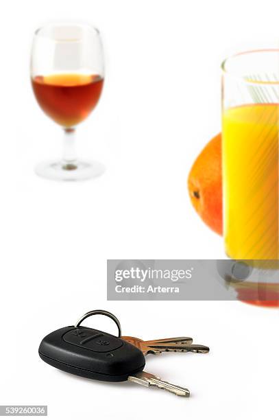Car key, alcohol and glass of fruit juice.