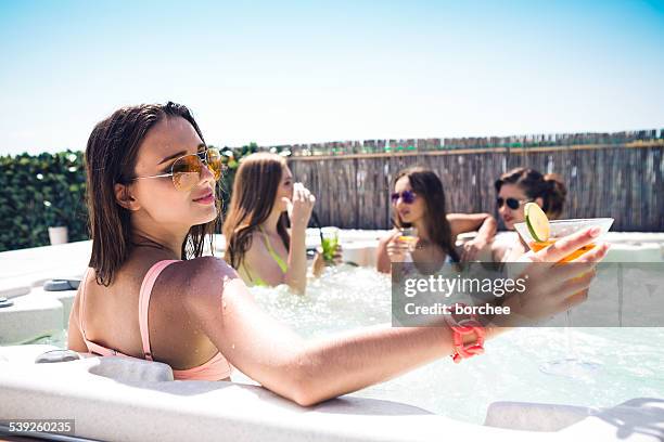 friends having fun in hot tub - girls in hot tub stockfoto's en -beelden