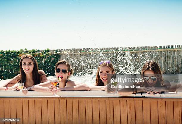 teenagers having fun in hot tub - girls in hot tub stockfoto's en -beelden