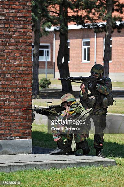 Shooting soldier on patrol on foot in street during demonstration at open day of the Belgian army at Leopoldsburg, Belgium.