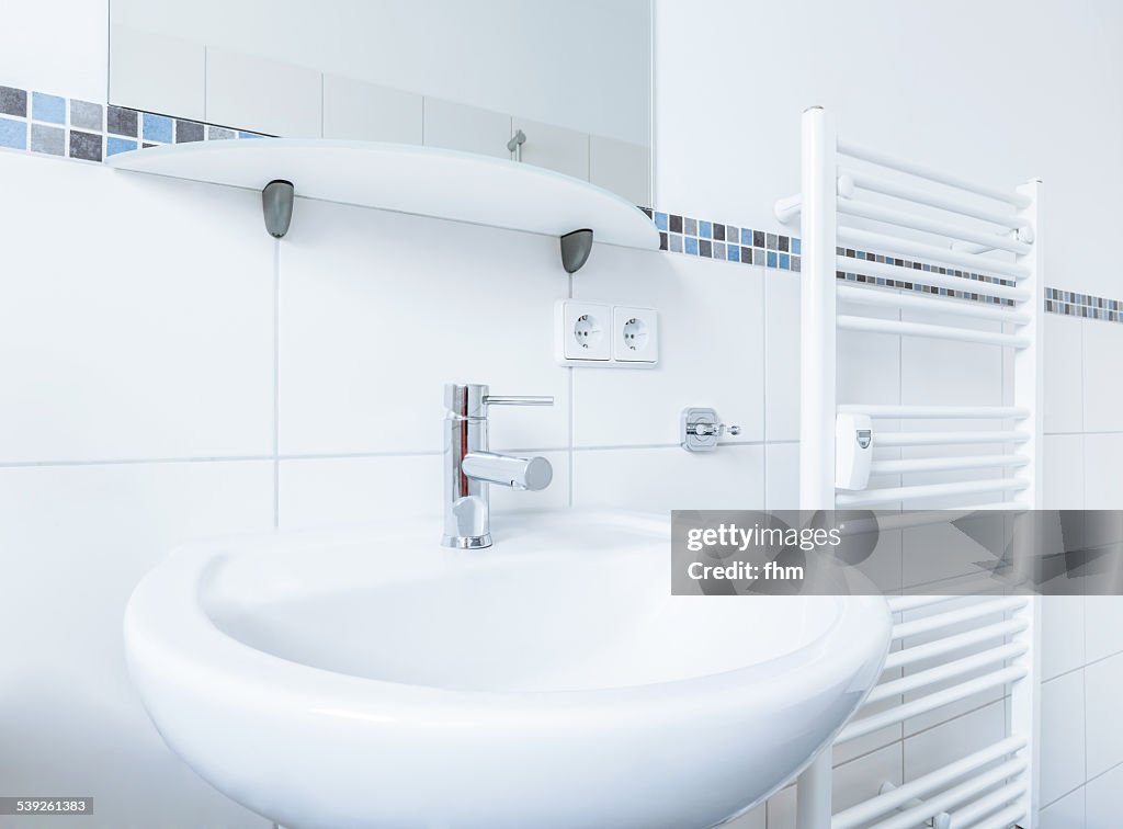 Washtub near a heater in renovated modern bathroom