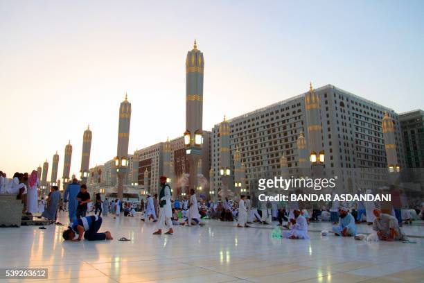 Muslim worshippers gather at the Prophet Mohammed Mosque during the Muslim holy fasting month of Ramadan on June 10, 2016 in the Saudi holy city of...