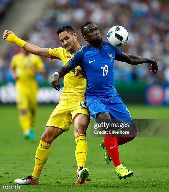 Bacary Sagna of France and Florin Andone of Romania compete for the ball during the UEFA Euro 2016 Group A match between France and Romania at Stade...