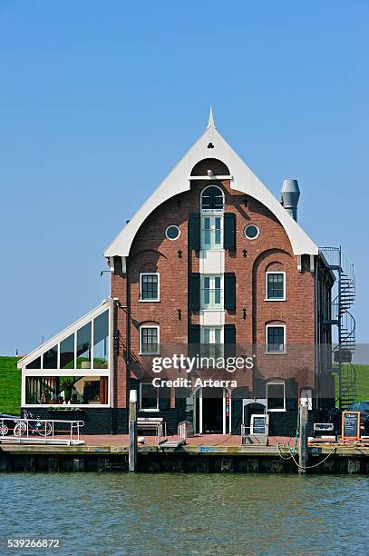 The historical warehouse / storehouse / entrepot is now a fish restaurant in the harbour of Oudeschild, Texel, Netherlands.