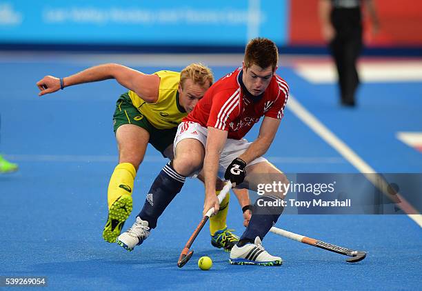 Henry Weir of Great Britain is tackled by Aran Zalewski of Australia during the FIH Men's Hero Hockey Champions Trophy 2016 - Day One match between...