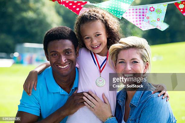 family at childs sports day - school award stock pictures, royalty-free photos & images