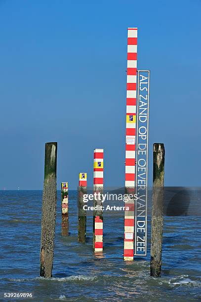 Sea tide depth measure / water level gauge on beach at low tide, Zeeland, Netherlands.