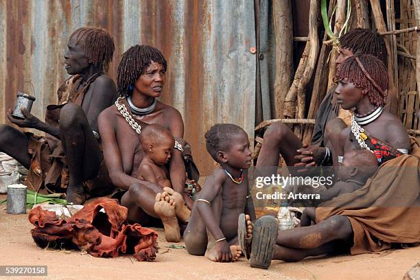 Women with children and babies of the Hamar Tribe sitting on the ground, Dimeka, South Omo / Debub Omo, Ethiopia, East Africa.