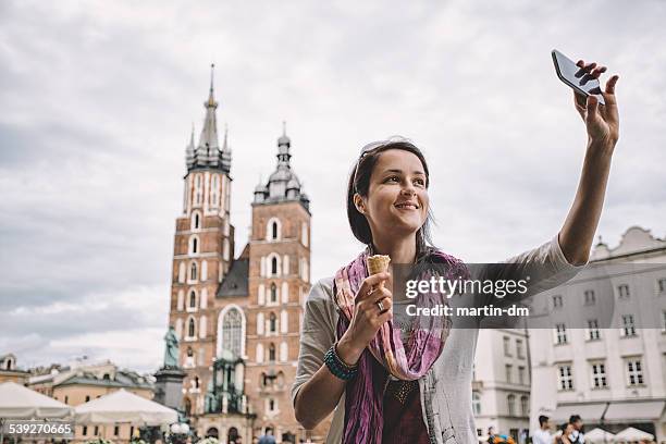 young girl at the main market square of krakow - krakow stock pictures, royalty-free photos & images