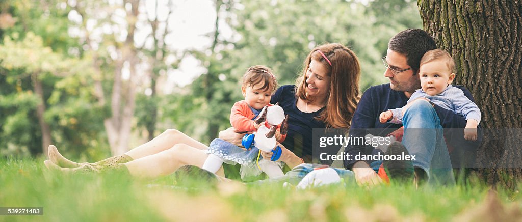 Happy parents with kids enjoying spring time in nature